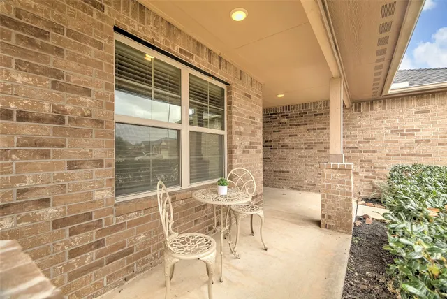 a balcony with furniture and a potted plant