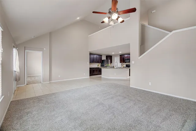 a view of a kitchen with a sink and chandelier fan