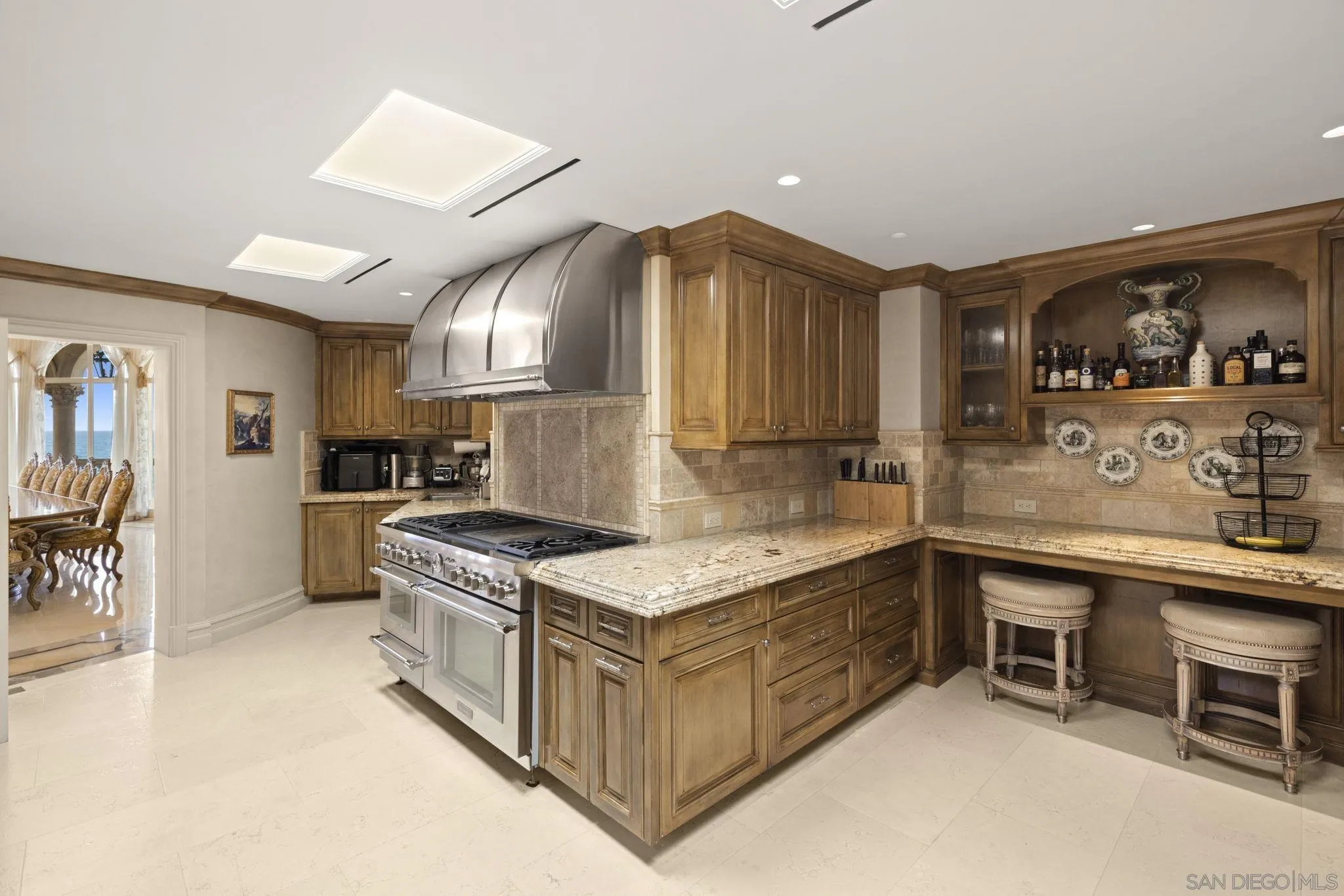 1900 Spindrift Drive La Jolla, CA 92037 - Photo 29 of 50 a kitchen with stainless steel appliances granite countertop a stove a sink and a refrigerator