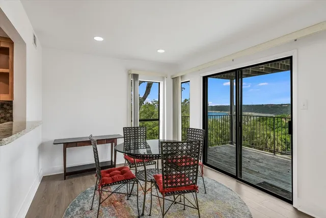 a living room with furniture and a floor to ceiling window