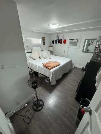 a bed sitting in a bedroom and table