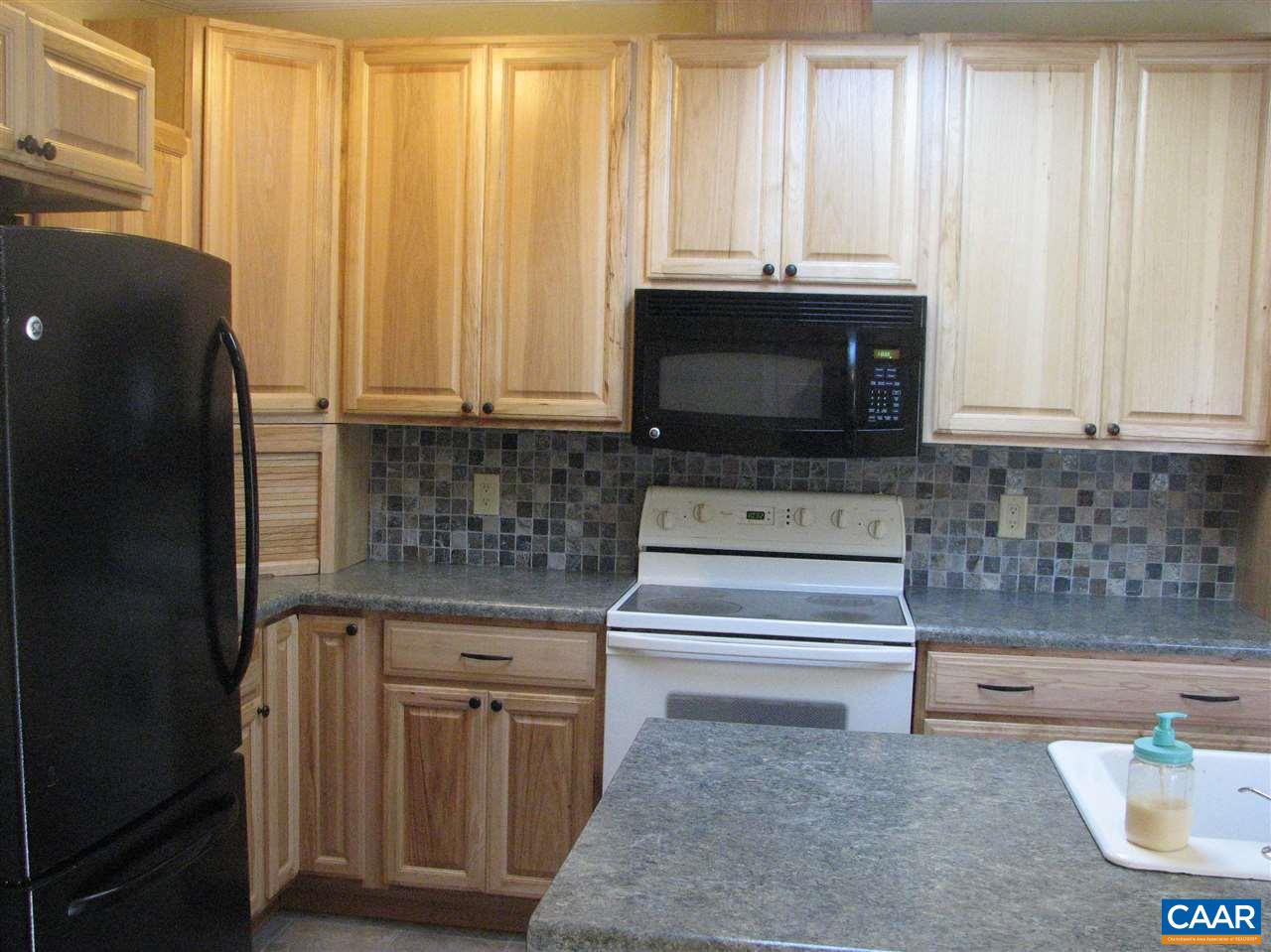 4247 Rising Sun Road Palmyra, VA 22963 - Photo 3 of 31 a kitchen with granite countertop a sink and a microwave
