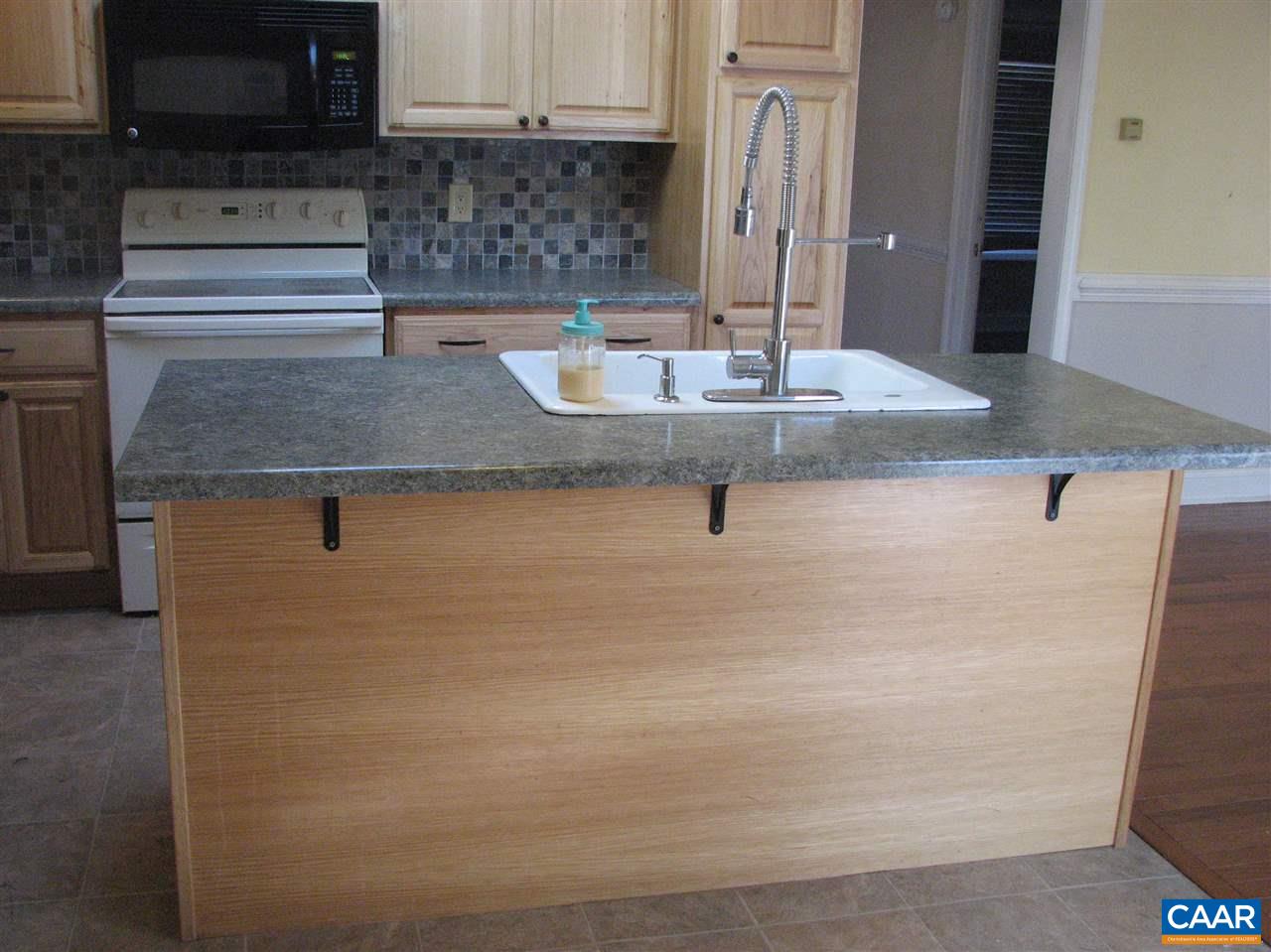 4247 Rising Sun Road Palmyra, VA 22963 - Photo 7 of 31 a kitchen with granite countertop a sink a stove and a microwave