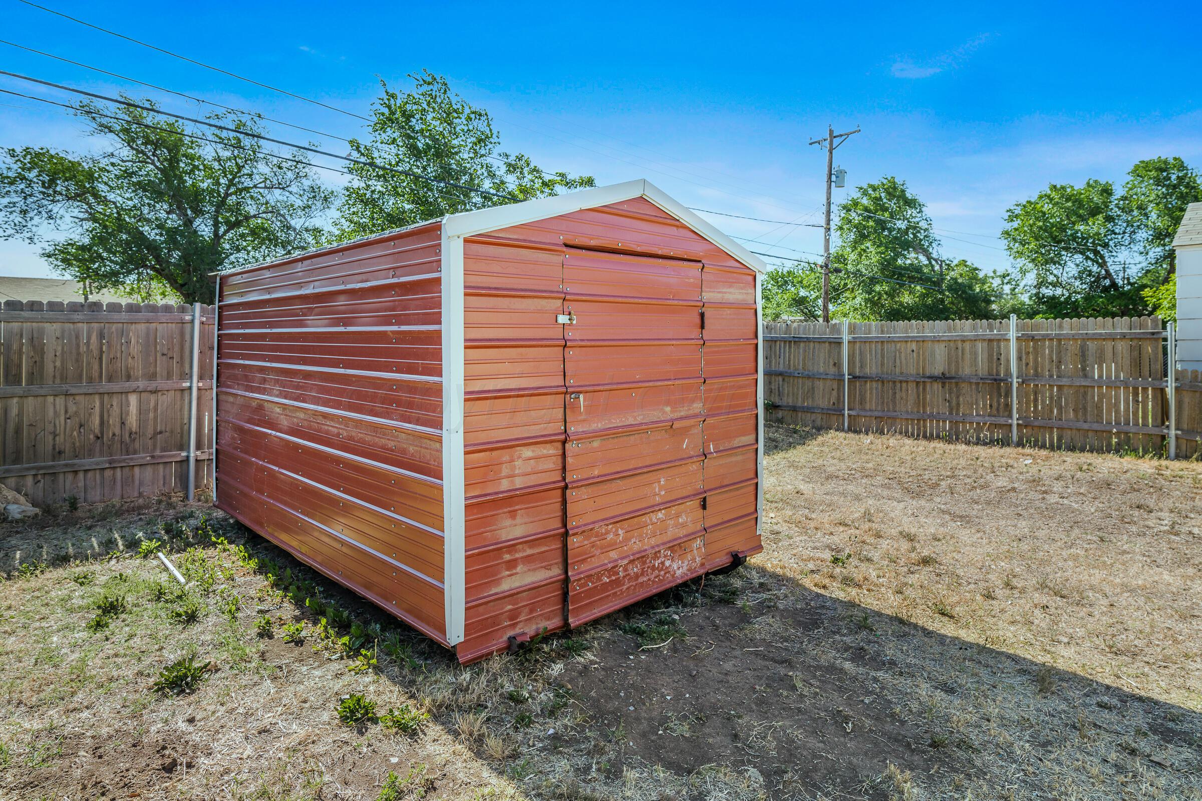 4429 Bowie Street Amarillo, TX 79110 - Photo 18 of 20 a view of a backyard with a small cabin