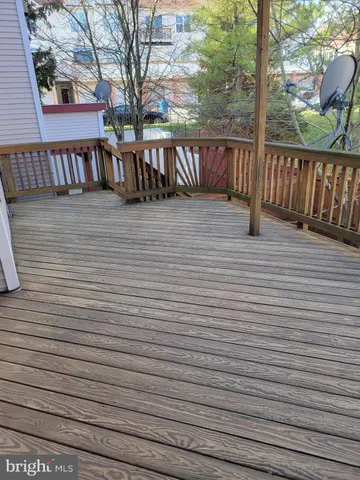 a view of a roof with wooden floor and floor to ceiling window