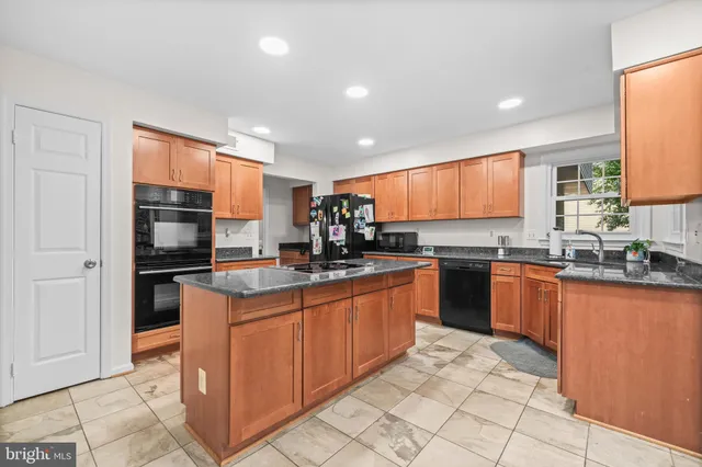 a kitchen with granite countertop sink cabinets and window
