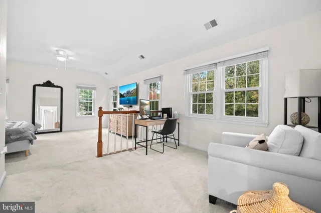 a spacious bedroom with a bed and a dresser