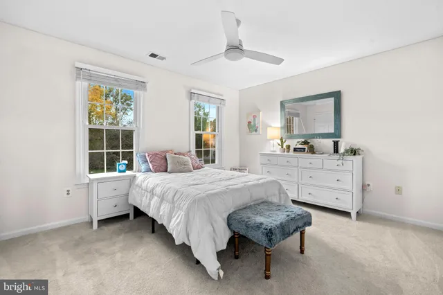 a living room with furniture and a book shelf
