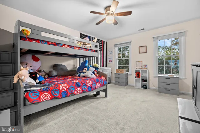 a living room with furniture kitchen view and a window