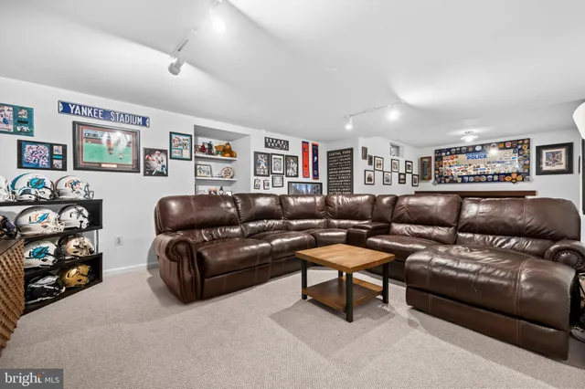 a bedroom with a bed and painting on the wall