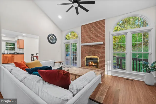 a living room with furniture tv and a fireplace