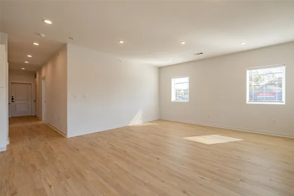 a view of kitchen with stainless steel appliances refrigerator oven and cabinets