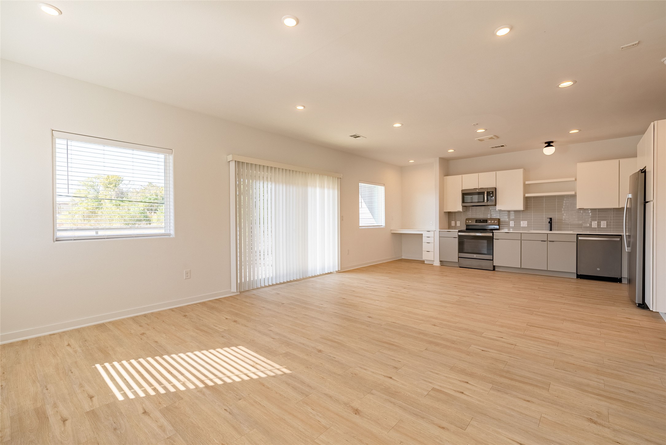 100 West Mockingbird Lane, Unit 201 Austin, TX 78745 - Photo 3 of 16 Unfurnished living room featuring recessed lighting and light wood-style flooring