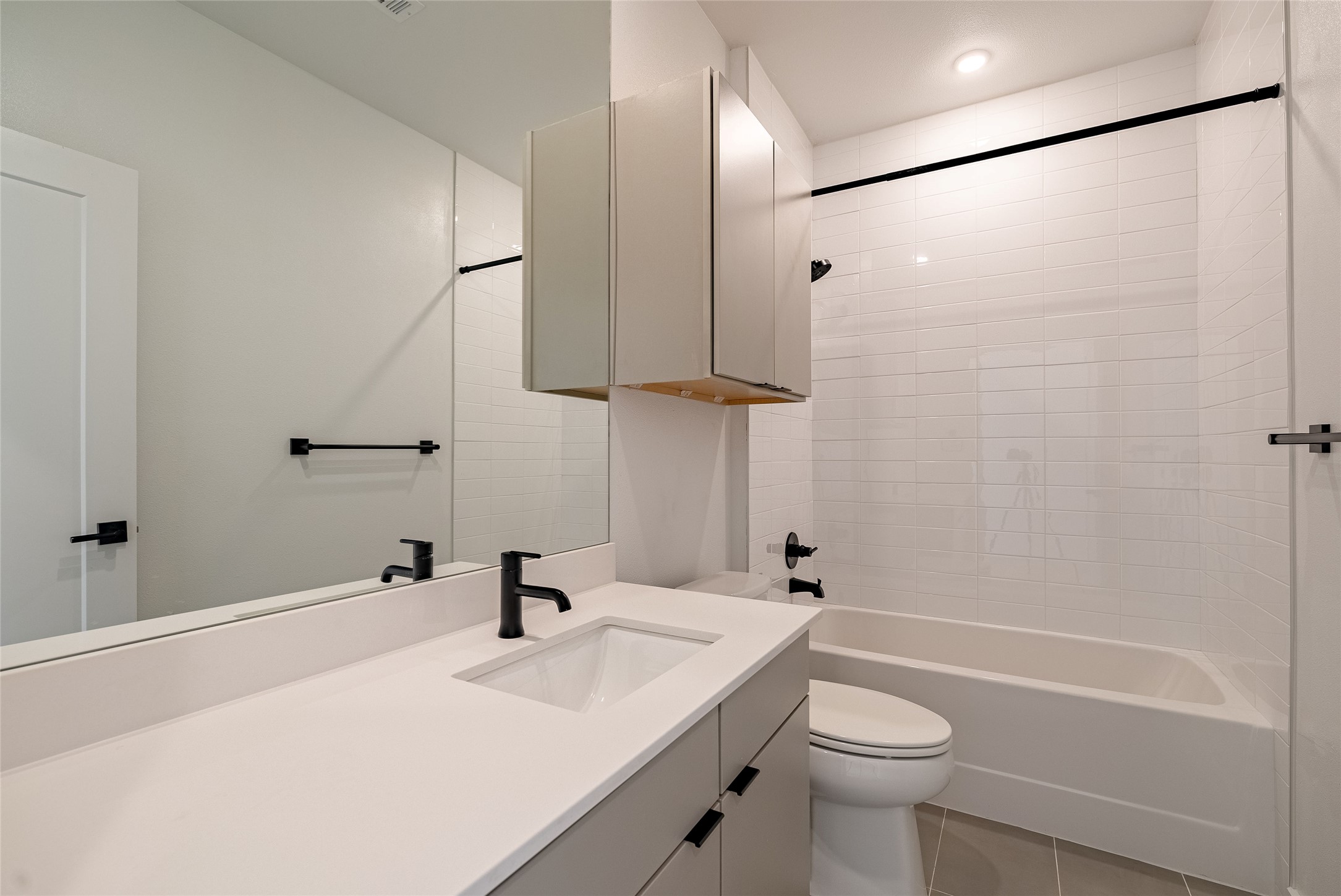 100 West Mockingbird Lane, Unit 201 Austin, TX 78745 - Photo 6 of 16 Bathroom with vanity, bathing tub / shower combination, and light tile patterned floors