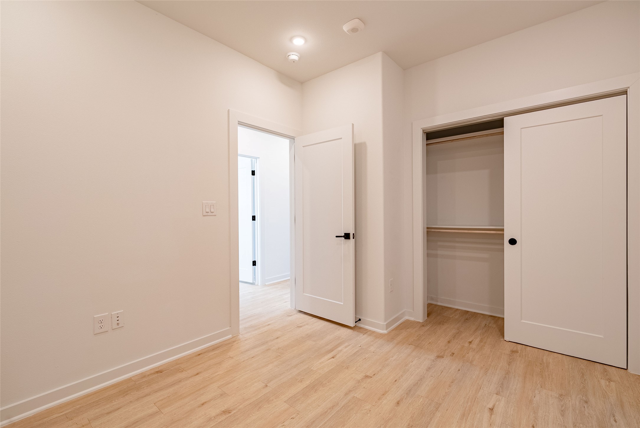 100 West Mockingbird Lane, Unit 201 Austin, TX 78745 - Photo 8 of 16 Unfurnished bedroom with light wood-style floors and a closet