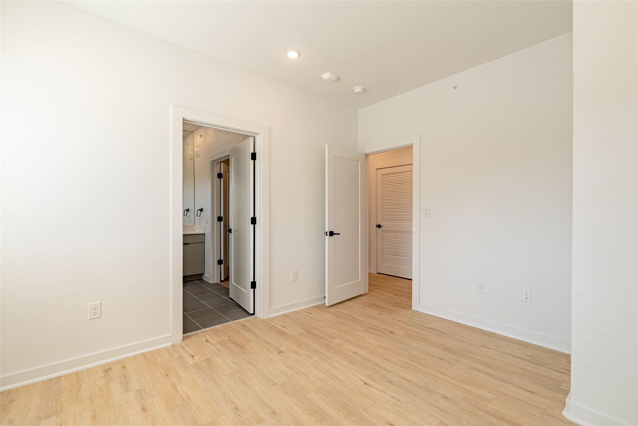 100 West Mockingbird Lane, Unit 201 Austin, TX 78745 - Photo 10 of 16 Spare room with light wood-style floors and baseboards
