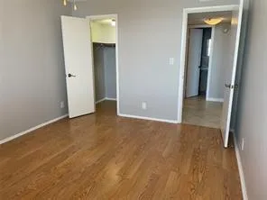 an empty room with closet and entrance