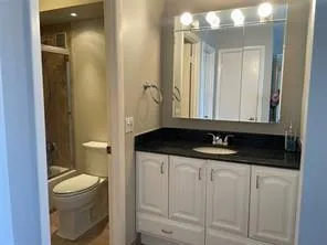 a bathroom with a shower and a toilet