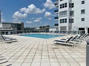 swimming pool view with a seating space