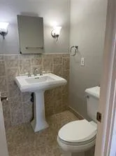 a white toilet sitting next to a white sink