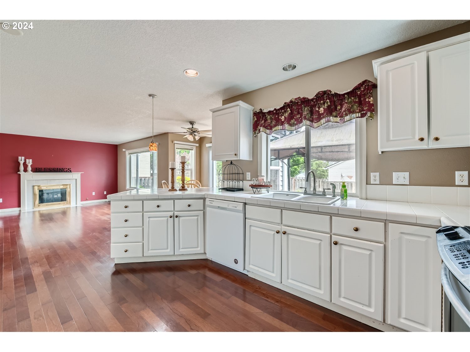 58916 Evergreen Loop St. Helens, OR 97051 - Photo 12 of 28 a kitchen with cabinets wooden floor and a window