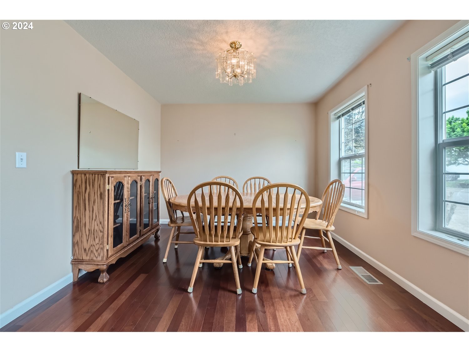 58916 Evergreen Loop St. Helens, OR 97051 - Photo 8 of 28 a dining room with furniture a chandelier and wooden floor