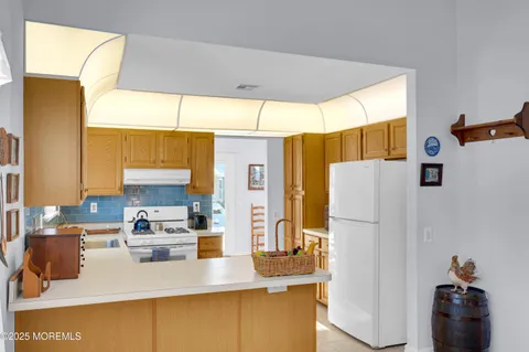 a kitchen with a refrigerator a stove and a refrigerator