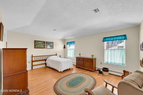 a bedroom with furniture and a wooden floor