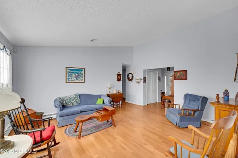 a living room with furniture a rug and a wooden floor