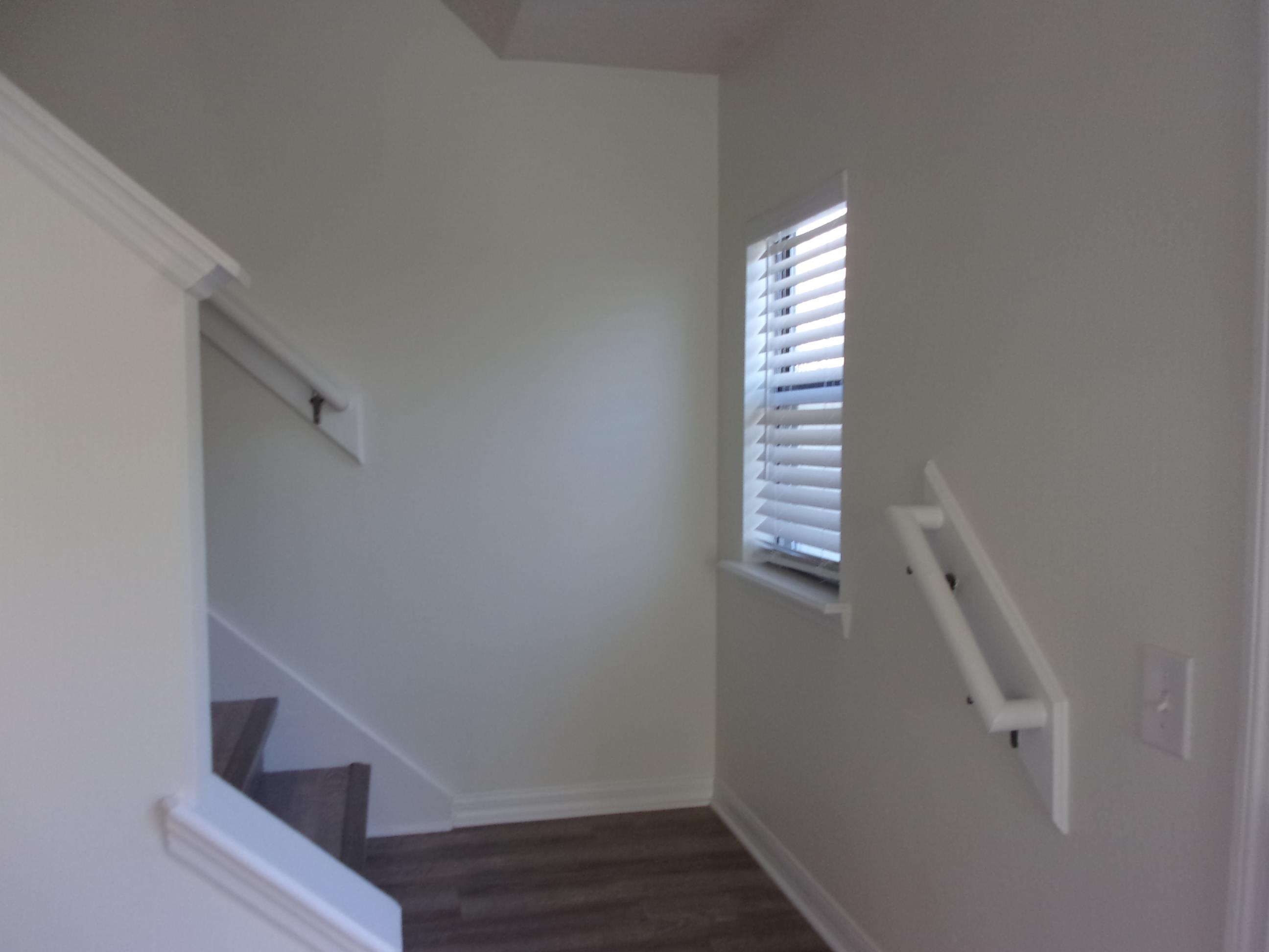 274 Syrah Way St. Augustine, FL 32084 - Photo 12 of 42 a view of staircase with wooden floor and white walls