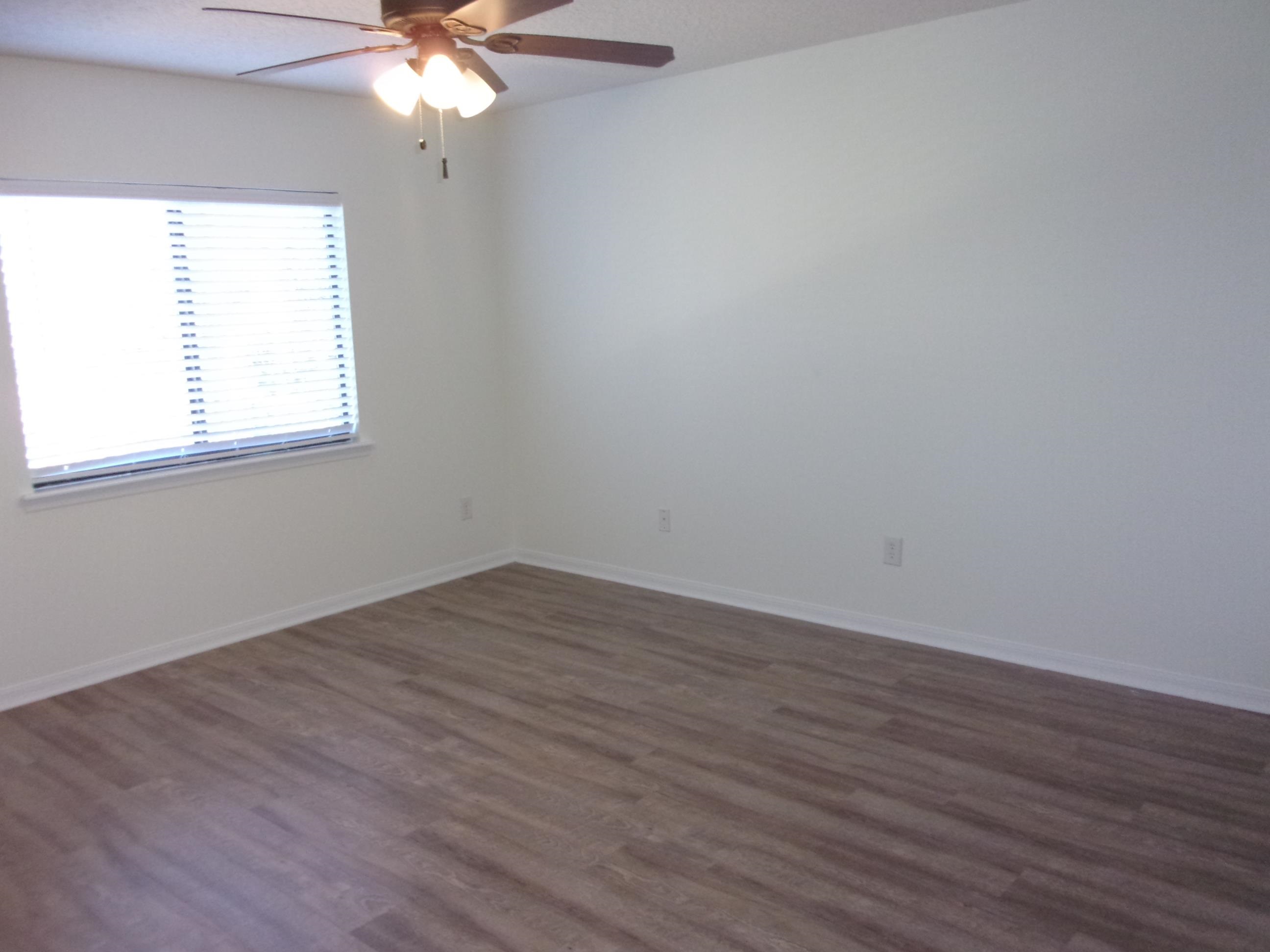 274 Syrah Way St. Augustine, FL 32084 - Photo 13 of 42 Empty room featuring dark wood-style flooring and ceiling fan