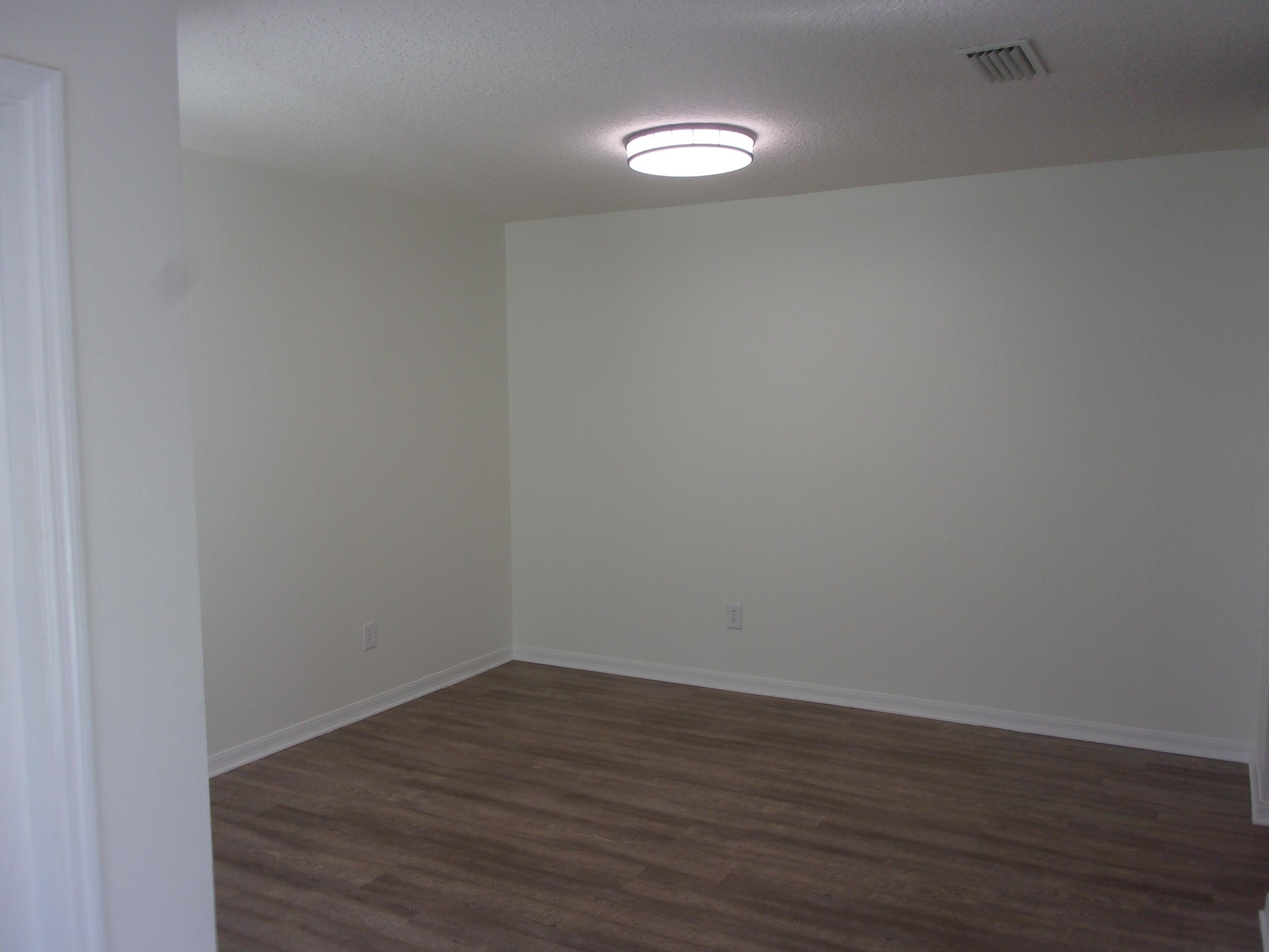 274 Syrah Way St. Augustine, FL 32084 - Photo 2 of 42 Empty room featuring dark wood finished floors and a textured ceiling