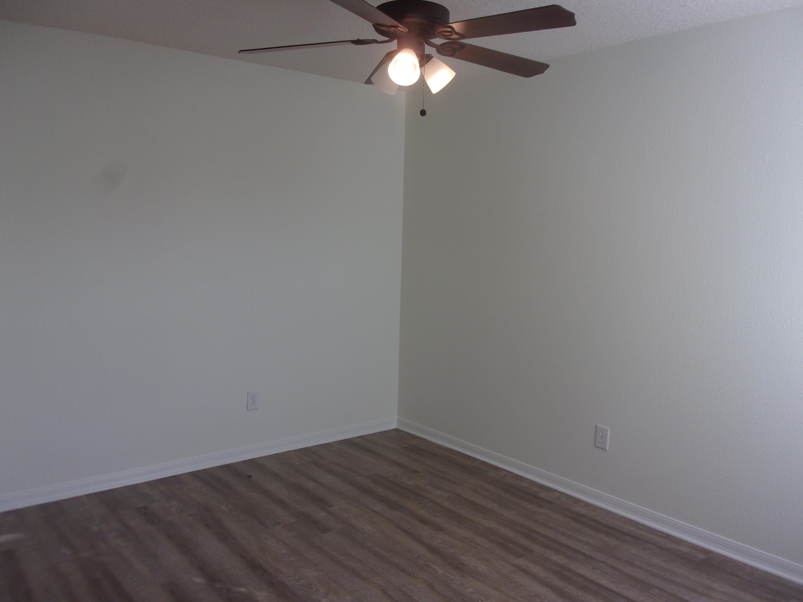 274 Syrah Way St. Augustine, FL 32084 - Photo 21 of 42 a view of an empty room with wooden floor and a ceiling fan