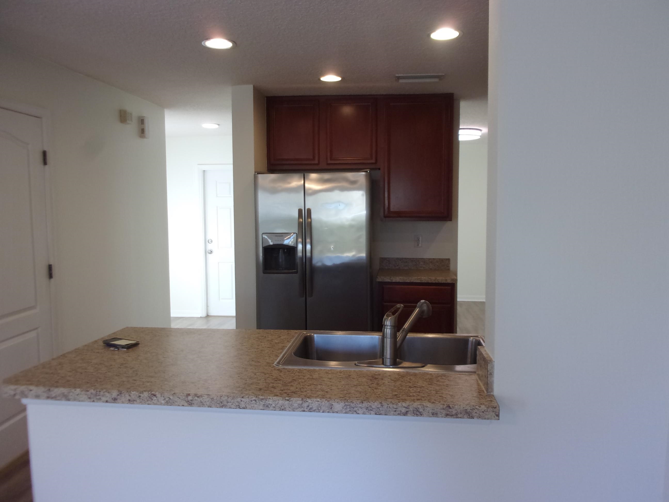 274 Syrah Way St. Augustine, FL 32084 - Photo 33 of 42 Kitchen featuring a peninsula, stainless steel fridge with ice dispenser, and recessed lighting