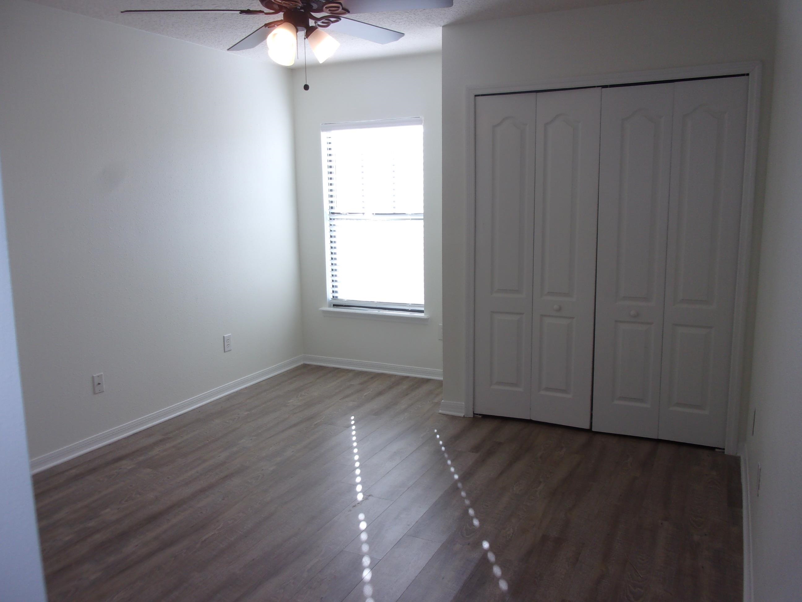 274 Syrah Way St. Augustine, FL 32084 - Photo 38 of 42 Unfurnished bedroom featuring a ceiling fan, dark wood-style flooring, and a closet