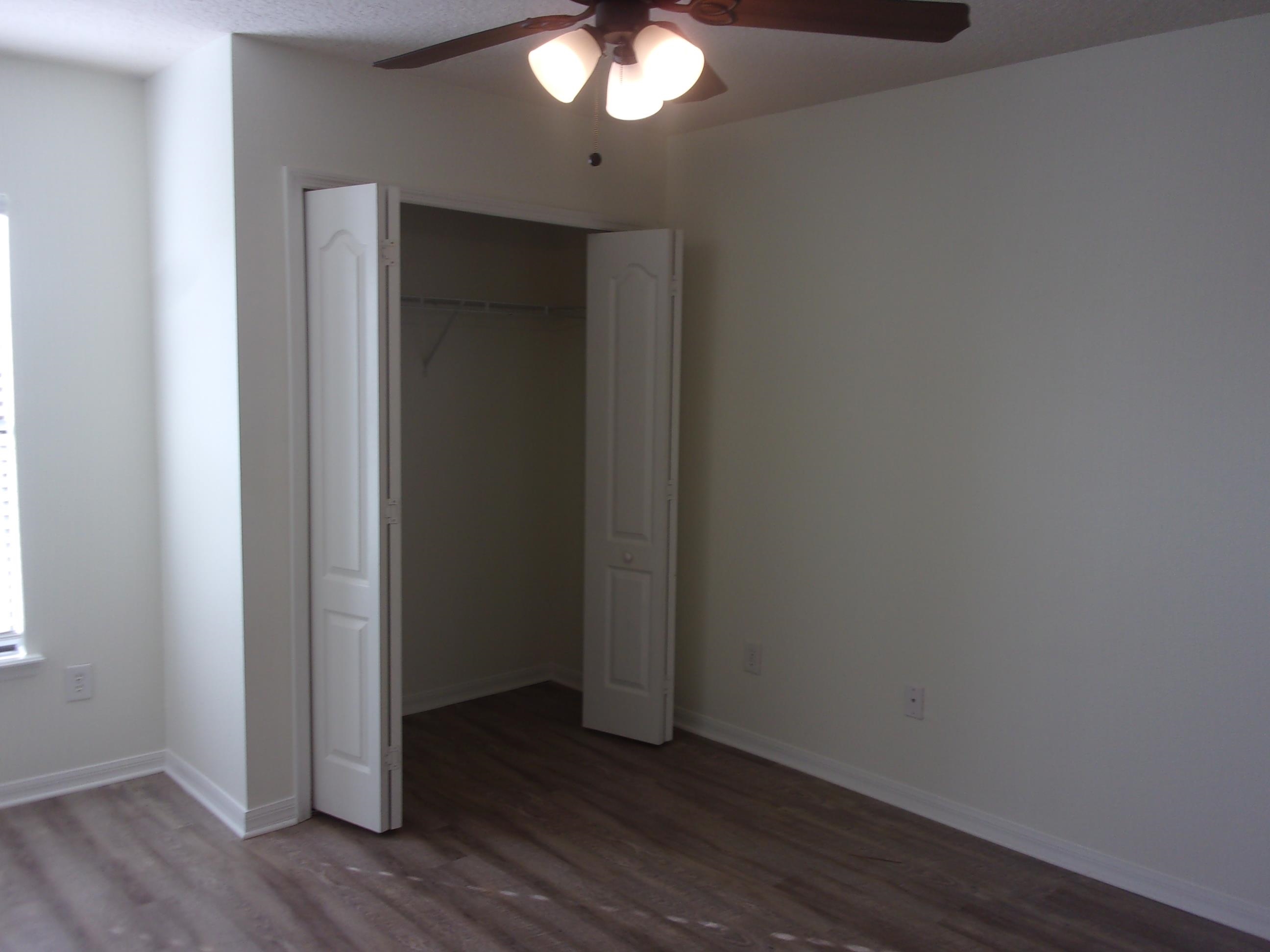 274 Syrah Way St. Augustine, FL 32084 - Photo 39 of 42 an empty room with wooden floor and windows
