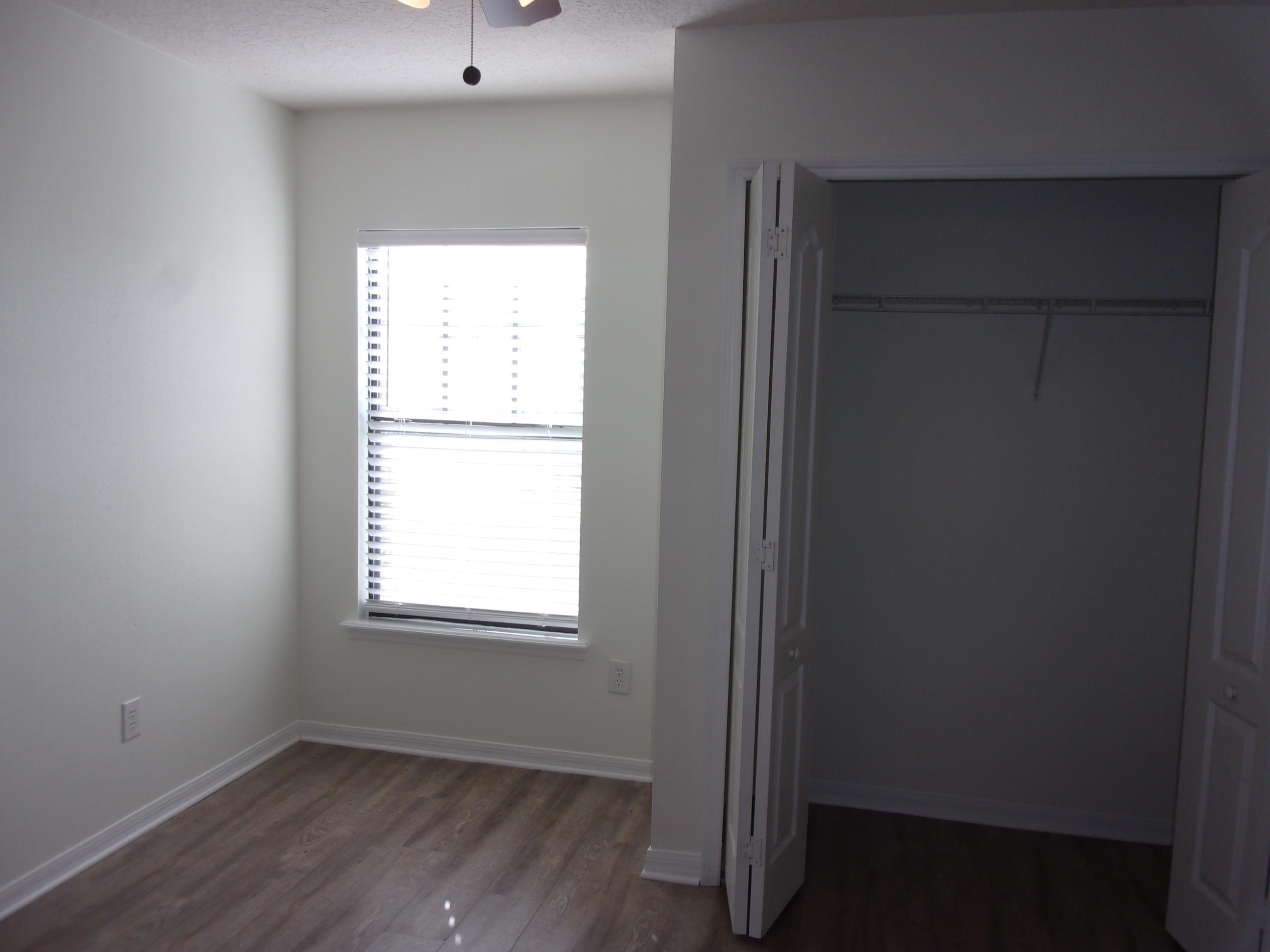 274 Syrah Way St. Augustine, FL 32084 - Photo 40 of 42 an empty room with wooden floor and windows