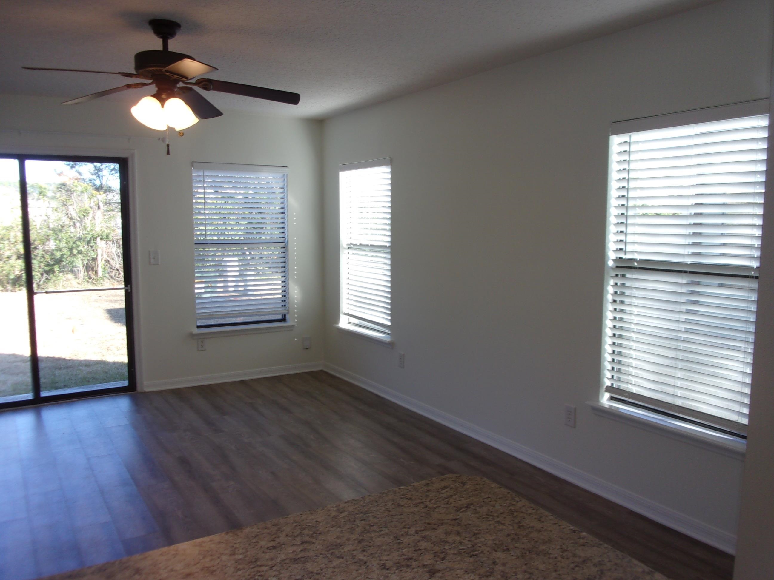 274 Syrah Way St. Augustine, FL 32084 - Photo 9 of 42 a view of an empty room with wooden floor and a window