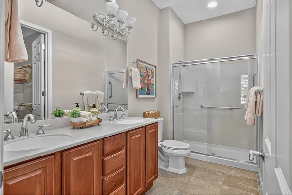 a spacious bathroom with a sink a toilet and shower