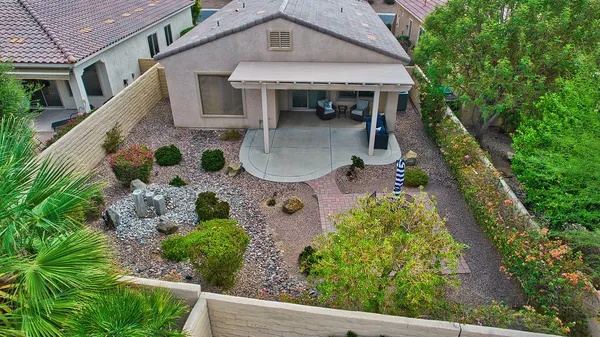 an aerial view of a house with swimming pool garden and patio