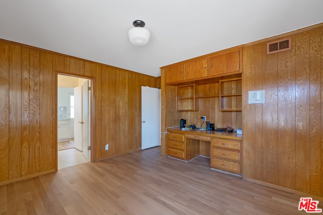 4245 Olympiad Drive View Park, CA 90043 - Photo 12 of 24 a view of a workspace with wooden floor and furniture