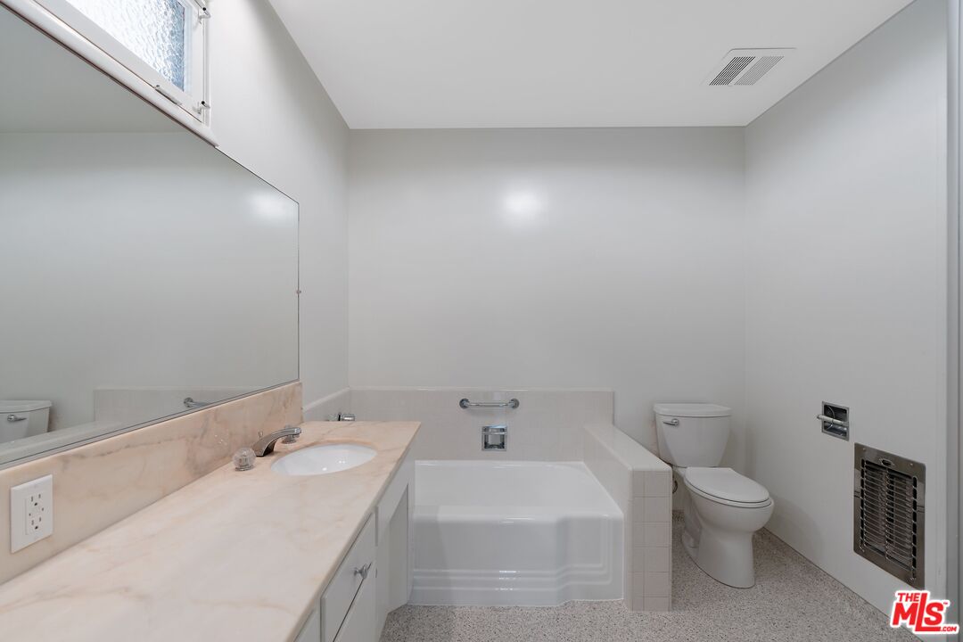 4245 Olympiad Drive View Park, CA 90043 - Photo 19 of 24 a bathroom with a toilet sink and mirror