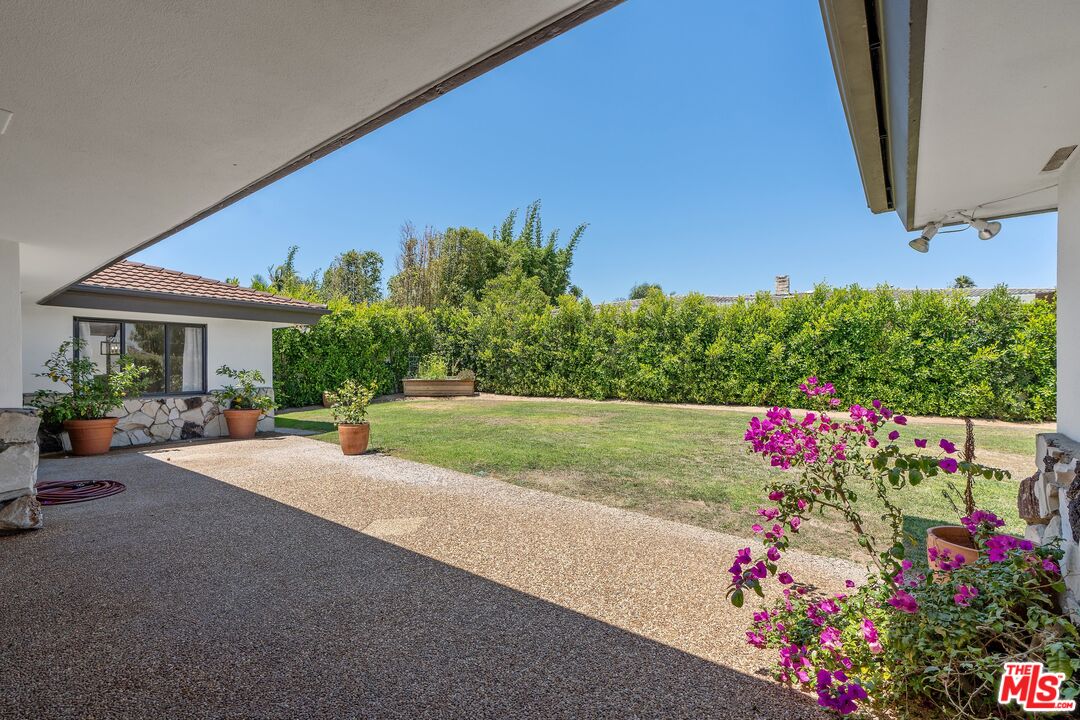 4245 Olympiad Drive View Park, CA 90043 - Photo 20 of 24 a flower garden is sitting in front of a house