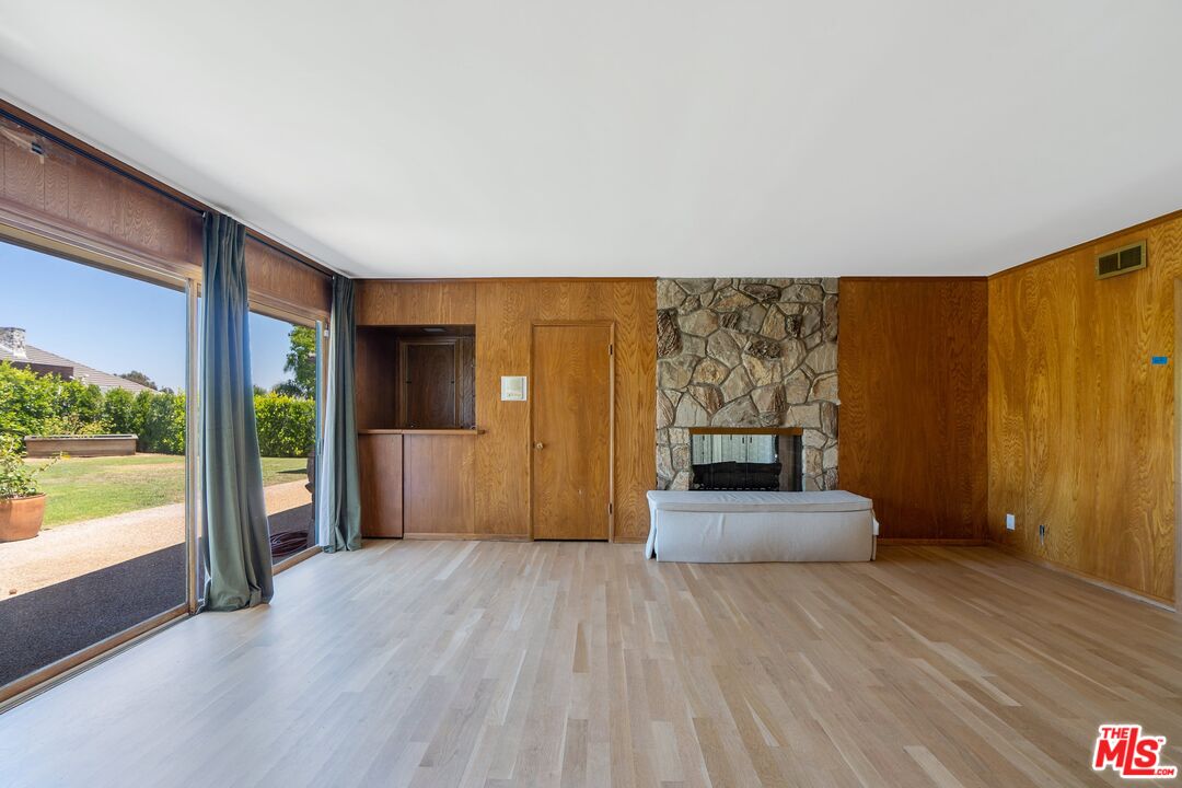 4245 Olympiad Drive View Park, CA 90043 - Photo 7 of 24 a view of a hallway with wooden floor and cabinet