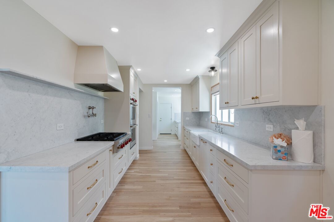 4245 Olympiad Drive View Park, CA 90043 - Photo 9 of 24 a large kitchen with stainless steel appliances lots of counter space and a sink