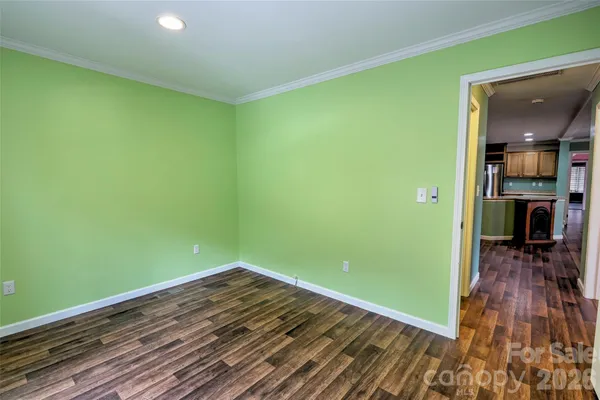a view of a room with wooden floor and a window