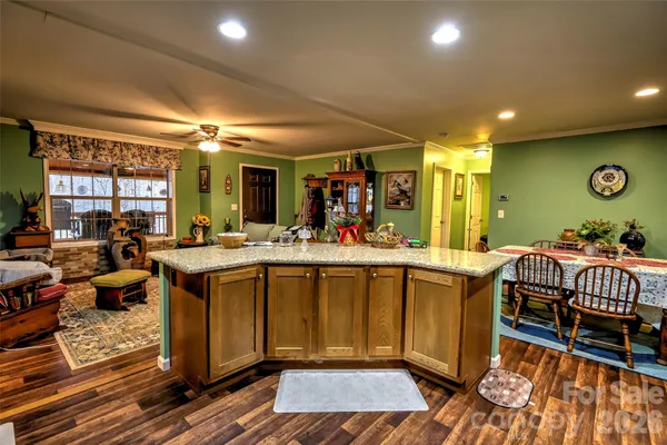 a kitchen with granite countertop a stove a sink and a microwave