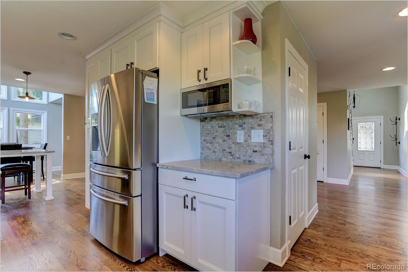 8401 Sweet Water Road Lone Tree, CO 80124 - Photo 17 of 35 a kitchen with stainless steel appliances a refrigerator stove and microwave