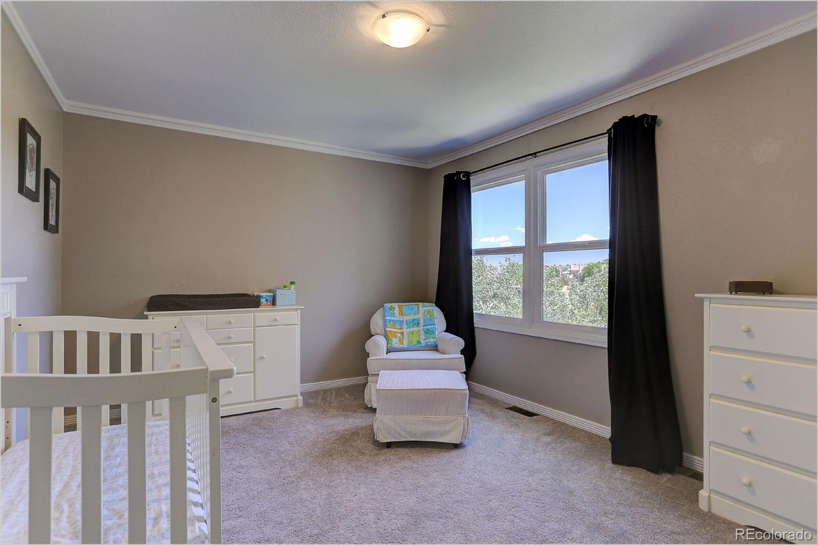 8401 Sweet Water Road Lone Tree, CO 80124 - Photo 24 of 35 a bedroom with furniture and a window