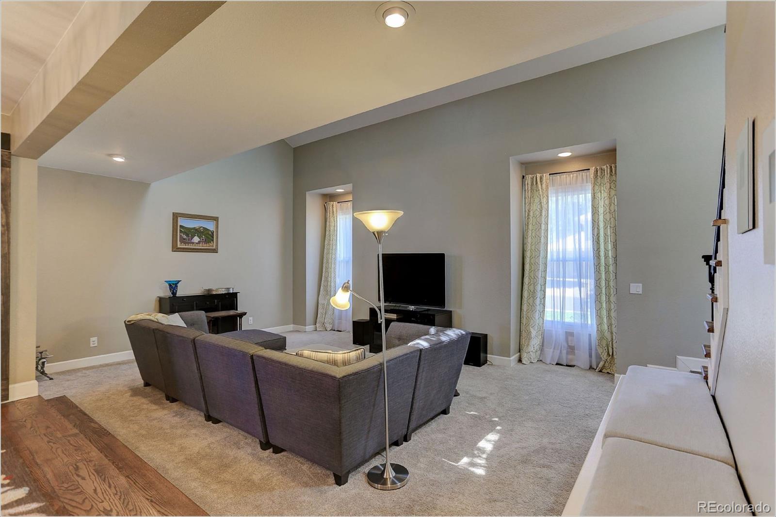 8401 Sweet Water Road Lone Tree, CO 80124 - Photo 6 of 35 a living room with furniture and a flat screen tv